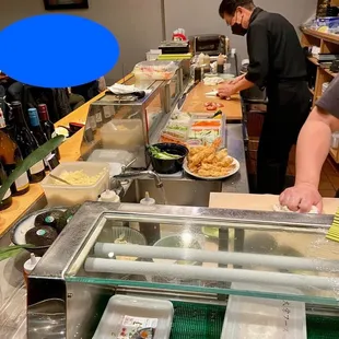 two people in a sushi restaurant