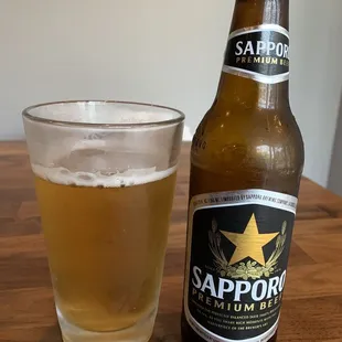 a glass and a bottle of sappor