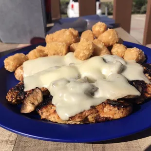 Grilled chicken breast smothered with Swiss cheese and mushrooms