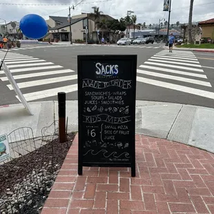a chalkboard sign on the sidewalk