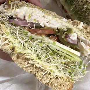 a person holding a sandwich