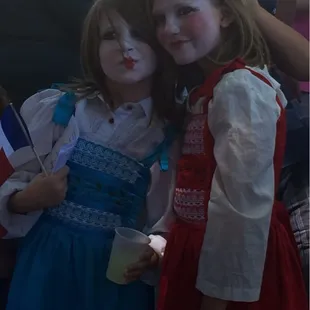Children with painted faces in costume.