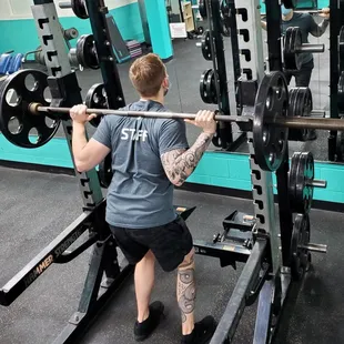 Man doing squats with barbell