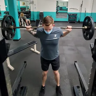 Man doing squats with barbell