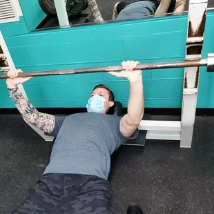 Man doing bench press with barbell