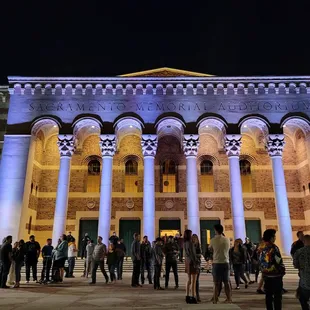 people standing in front of the building