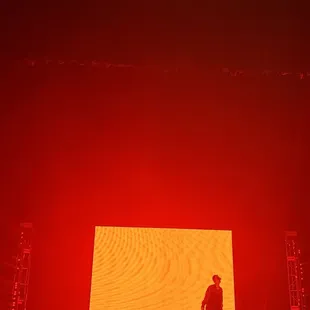 a man standing on a stage in front of a crowd