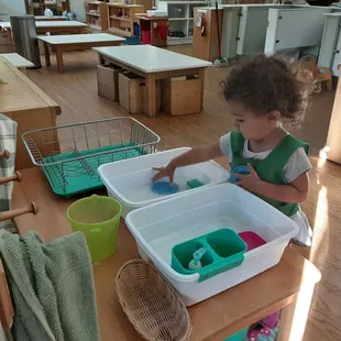 Washing dishes practical life job inside the toddler community.