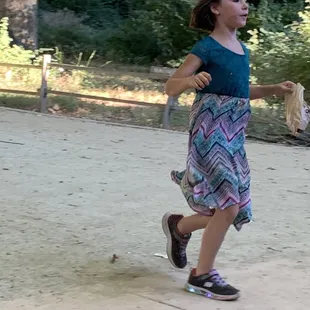 A happy child who is done with her performance of playing her fiddle.