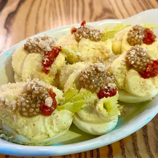 a plate of deviled eggs on a wooden table