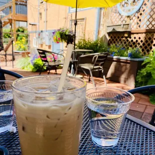 a cold beverage on a table with a yellow umbrella