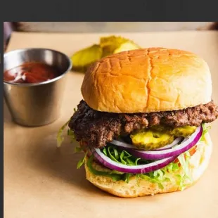 a hamburger with pickles and onions