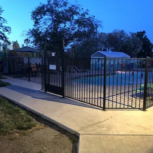 The pool and the playground structure at dusk