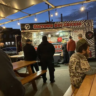 people sitting at picnic tables