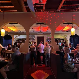 people sitting at tables in a restaurant