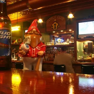 a statue of a beer gnome at a bar