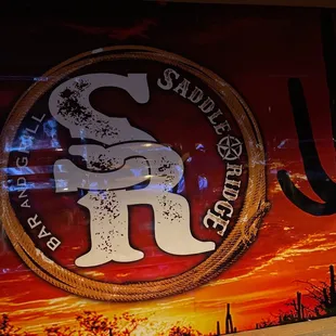 the logo of the saddle ridge cowboy club