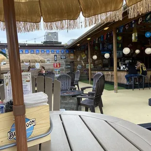 a table with an umbrella and chairs