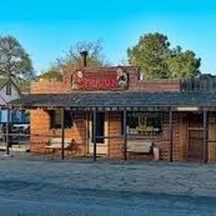 an old western building with a sign for saddle sore