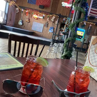 two glasses of drink on a table