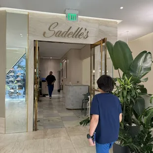 a woman walking into a hotel lobby