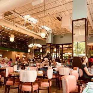 people sitting at tables in a restaurant