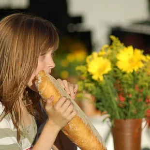 a girl eating a baguet