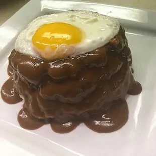 Loco Moco - Two hamburger patties topped with brown gravy and an egg.