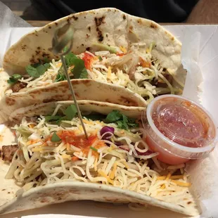 three tacos on a paper plate