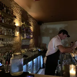 a bartender preparing a drink at a bar