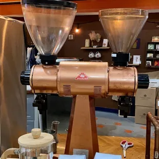 a coffee grinder and two bags of coffee