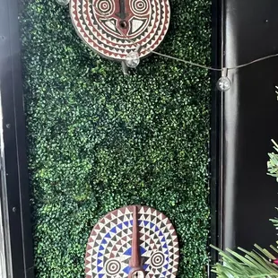 two decorative clocks on a wall