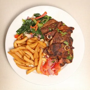 Mbuzi choma (grilled goat), chips and salad