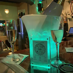 a bottle of champagne and two glasses of wine