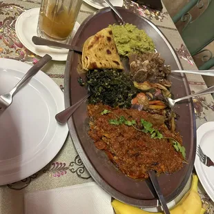 tilapia, goat, vegetable stir fry, mashed potato&apos;s and peas, collard greens and spinach