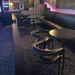 a bar with black leather seating