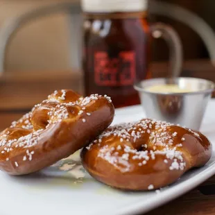 two glazed donuts on a white plate
