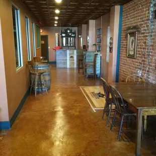 a long hallway with tables and chairs