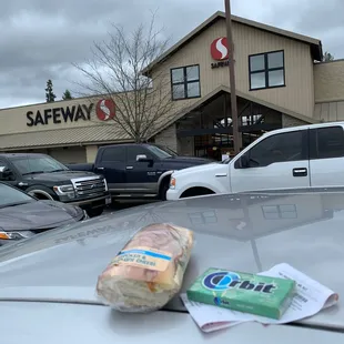 Safeway storefront as viewed from my car with my purchases on top of my car.