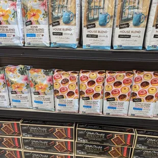 a variety of coffees on display in a grocery store