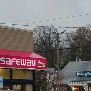 a red car parked in front of a store