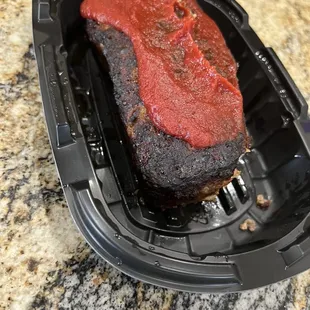 Old burnt meatloaf. Put some more ketchup on it and nobody will notice.