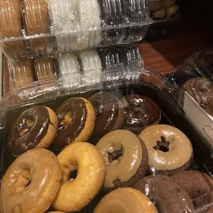 a variety of donuts in plastic containers