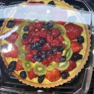 a fruit tart in a plastic container