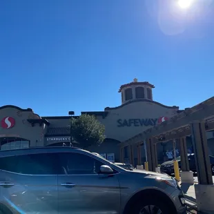 a car parked in front of a safeway store