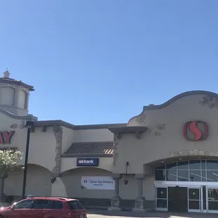 a car parked in front of a safeway store