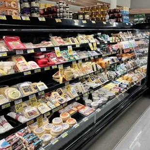 a display of cheeses in a grocery store