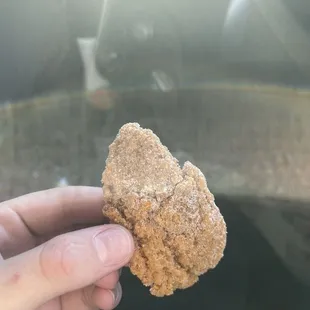 a hand holding a piece of food