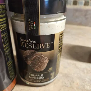 a jar of salt and a can of pepperoni