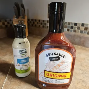 a bottle of bbq sauce next to a bottle of bbq sauce